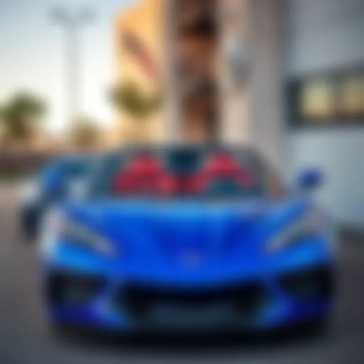 A shiny blue 2023 C8 Corvette convertible parked outside, showcasing its sleek design and low mileage, with a price tag of $70K.