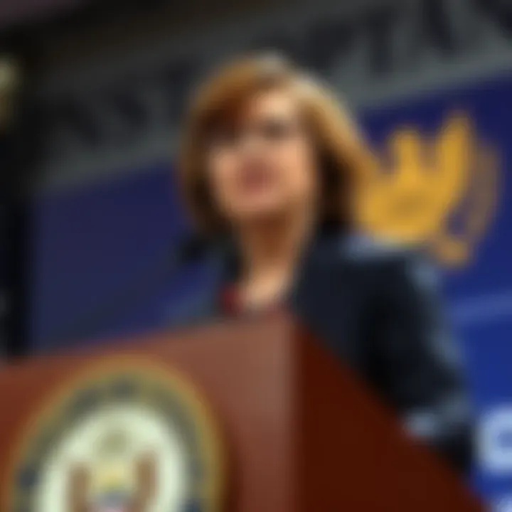 Boston Fed President Susan Collins speaks at a podium about the potential effects of the Iran conflict on energy prices and interest rates.