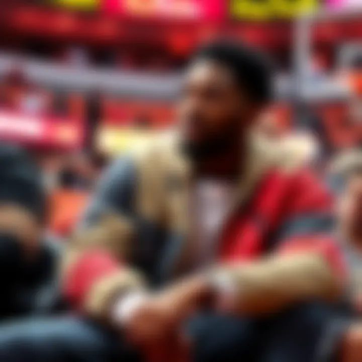 Damian Lillard's Stylish Courtside Outfit Damian Lillard sits courtside wearing a trendy outfit, showcasing his fashion sense during the NBA playoffs.