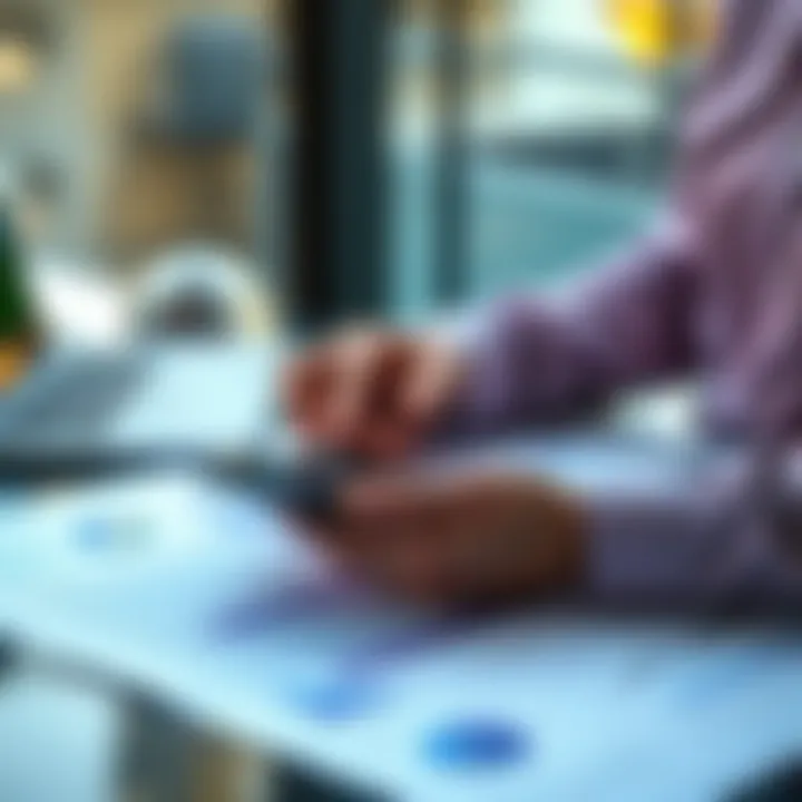 A person analyzing real estate investment documents with a calculator and laptop, symbolizing trust and investment strategies in real estate tokenization platforms.