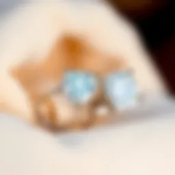 Two rings side by side A close-up of two diamond rings, one 2ct and one 2.5ct, placed side by side on a soft cloth for comparison.